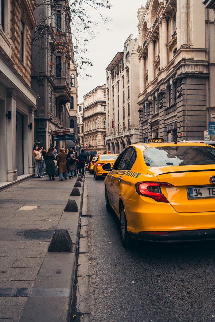 services-img Yellow taxis line a historic street in Istanbul, embodying urban life in Turkey's bustling city.